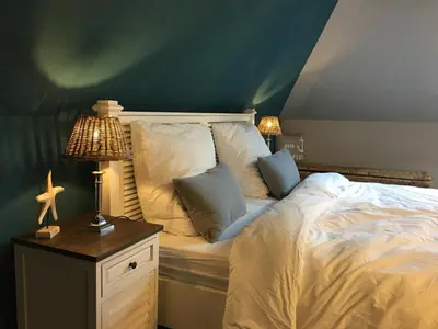 Ein Bett oder Betten in einem Zimmer der Unterkunft Strandappartment Meerkieker