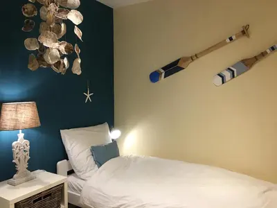 Ein Bett oder Betten in einem Zimmer der Unterkunft Strandappartment Meerkieker