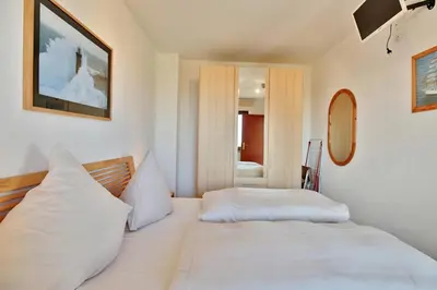 Ein Bett oder Betten in einem Zimmer der Unterkunft Haus Strandallee 24 Haus Strandallee 24 - Appartement Seemanns Meeresblick
