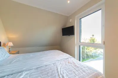 Ein Bett oder Betten in einem Zimmer der Unterkunft Ferienwohnung Beachbreak - Stilvolle Ferienwohnung an der Ostsee