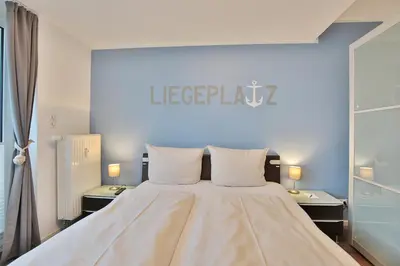 Ein Bett oder Betten in einem Zimmer der Unterkunft Strandduene Stranddüne Appartement 23