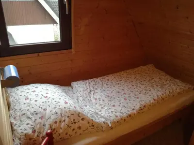Ein Bett oder Betten in einem Zimmer der Unterkunft Ferienhaus Suda