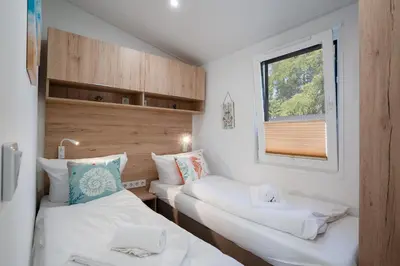 Ein Bett oder Betten in einem Zimmer der Unterkunft Ostseecamp Lübecker Bucht Haus 