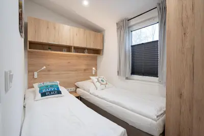Ein Bett oder Betten in einem Zimmer der Unterkunft Ostseecamp Lübecker Bucht Ferienhaus 