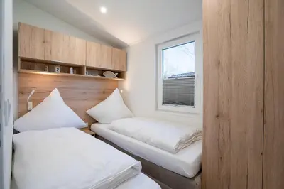 Ein Bett oder Betten in einem Zimmer der Unterkunft Ostseecamp Lübecker Bucht Ferienhaus 