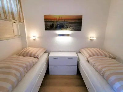 Ein Bett oder Betten in einem Zimmer der Unterkunft Ferienpark Sierksdorf App 193 - Strandlage Strandkorb