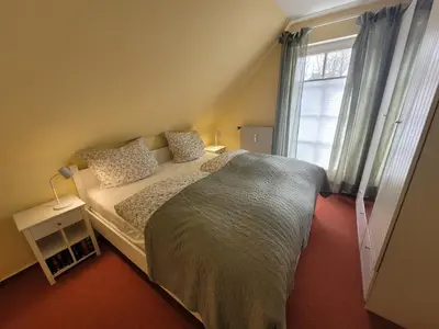 Ein Bett oder Betten in einem Zimmer der Unterkunft Rosenperle de - FeWo in Timmendorfer Strand